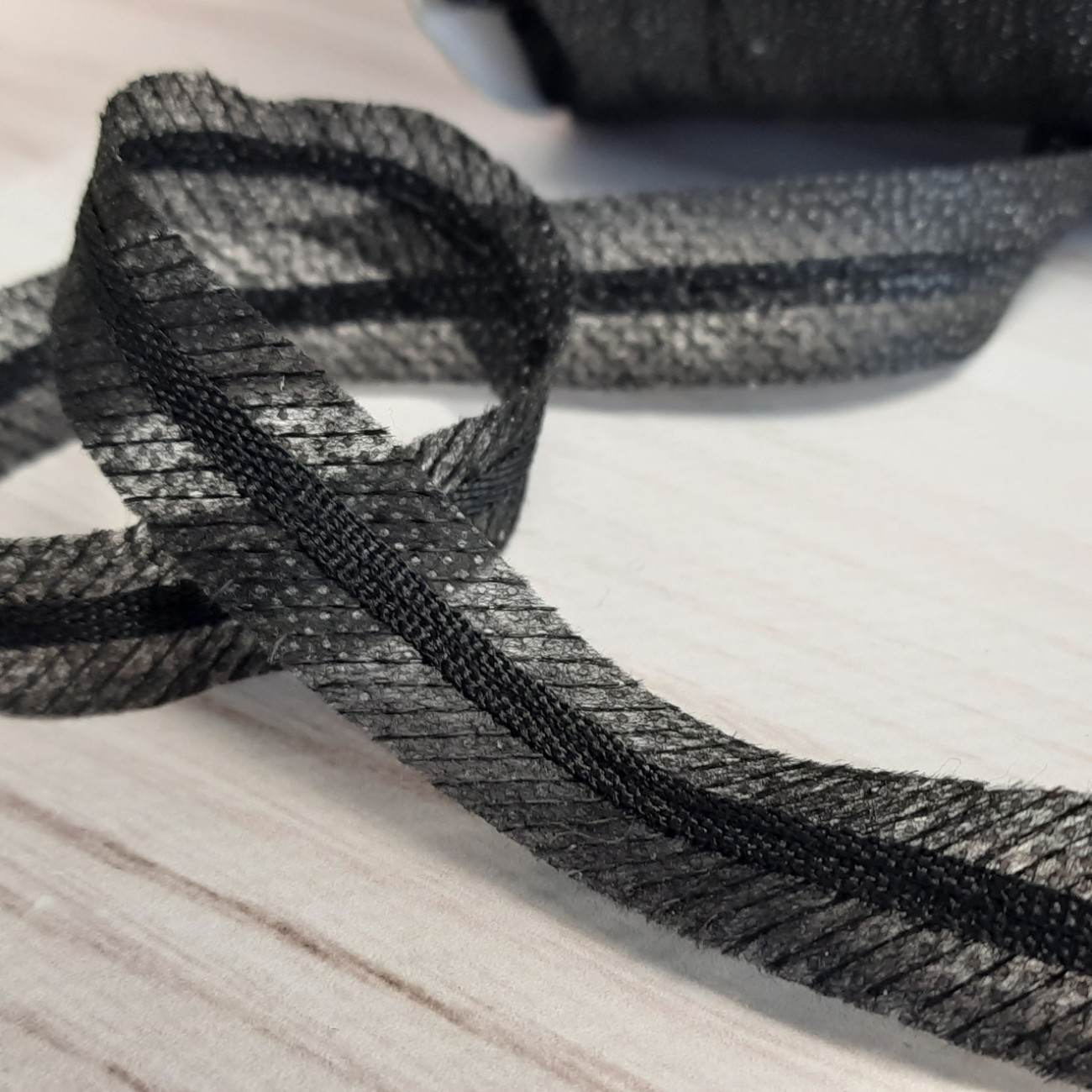 Тасьма клейова по косій, посилена стрічкою (чорна)