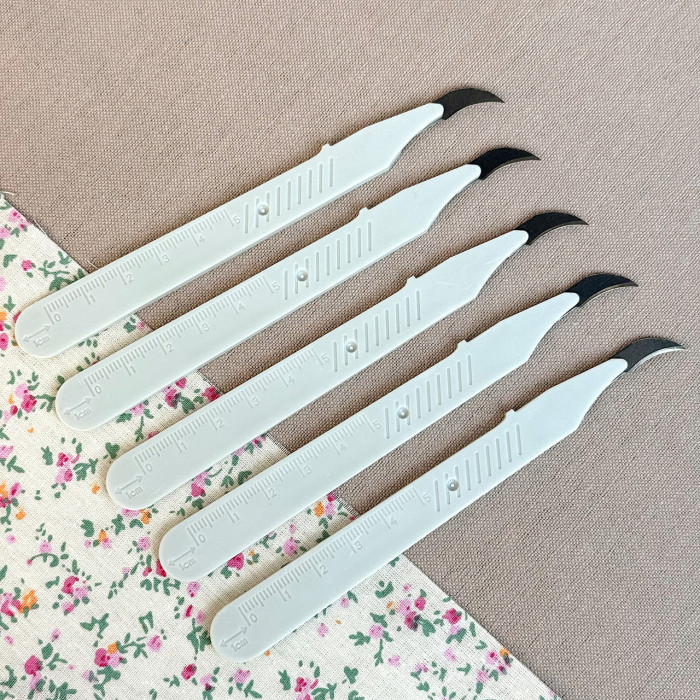 Розпорювач швів вигнутий молочний